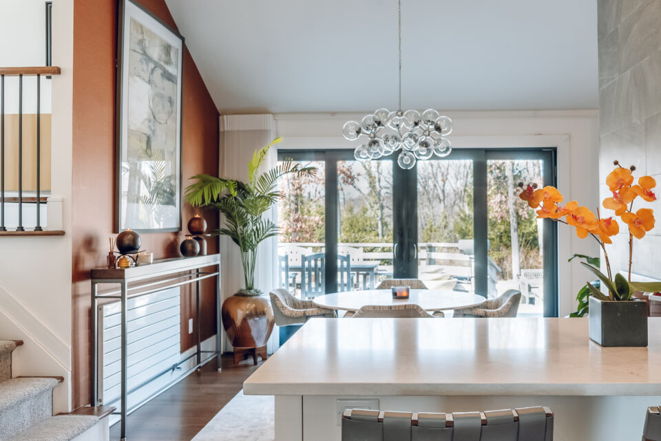light shining through glass doors onto a glowing kitchen and dining room table